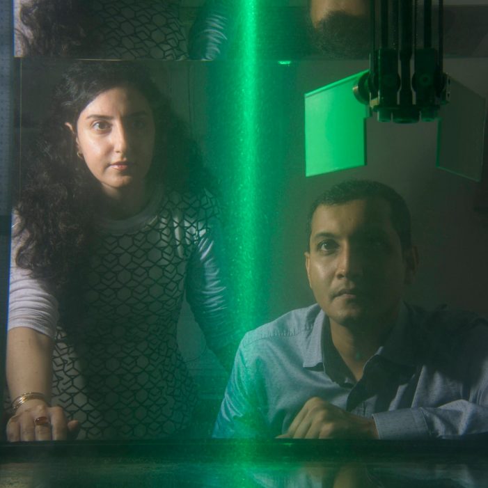 Dr Soudeh Mazharmanesh and Dr Sridhar Ravi Dr Soudeh Mazharmanesh and Dr Sridhar Ravi from the University of NSW Canberra watch illuminated particles flow through a tank while testing a wing shape. The researchers work examines how insects can give insights into drone engineering.