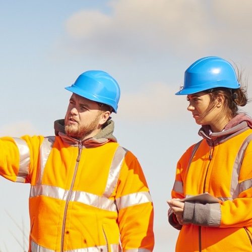 Two Engineers on site Two engineers assessing something in the distance on site