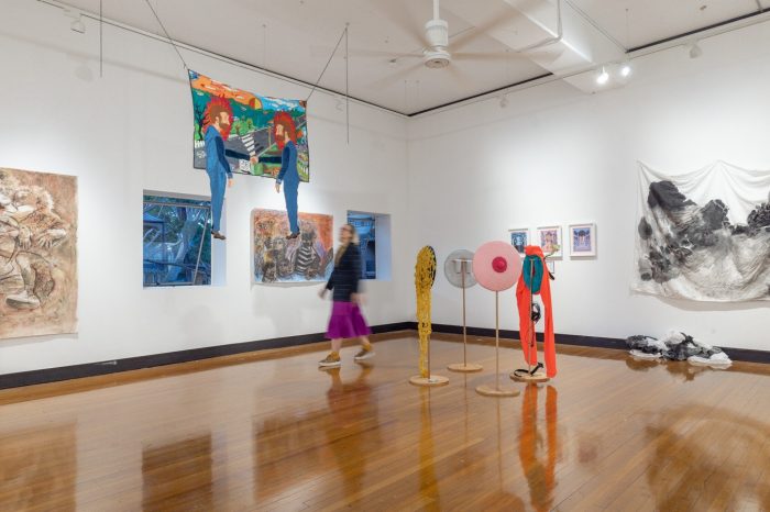 Girl walking around gallery of artwork