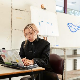 Arts student working in the studio on a laptop