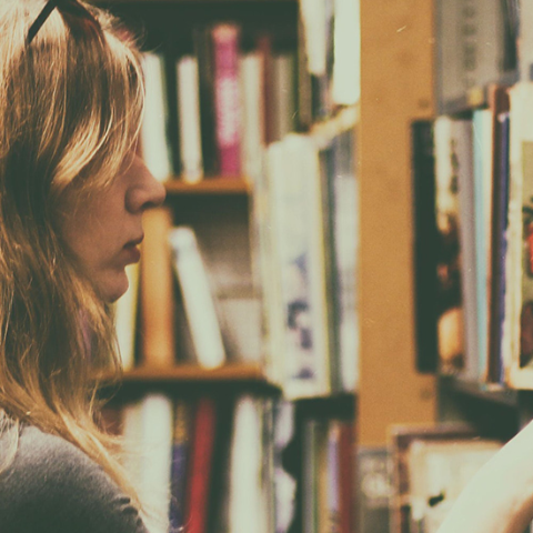 Student reading a book in library