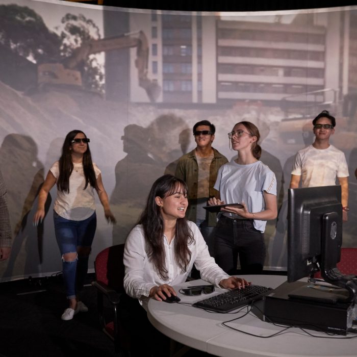 Students and teacher operate learning in a virtual reality cinema.