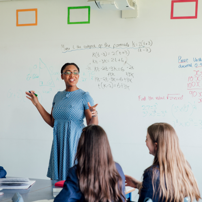 Female teacher discussing STEM: Mathematics during class.