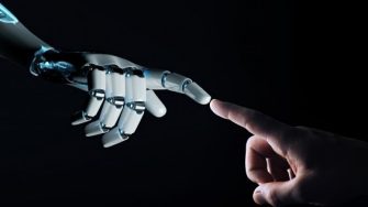 White robot finger about to touch human finger on dark background