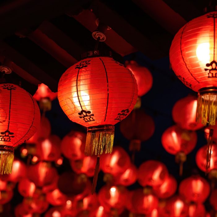 Rows of colorful glowing red Chinese lanterns hanging high at temple ground during Chinese New Year Celebrations at Thean Hou Temple, Kuala Lumpur Malaysia.