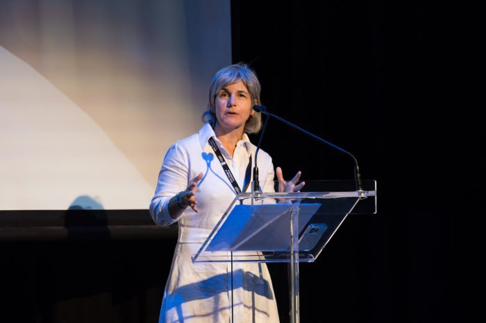 Prof Claire Annesley welcoming guests to the Massive Action Sydney Unconvention in the Roundhouse on 13 March 2024 