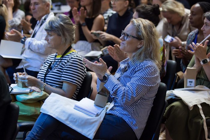 Guests at the Massive Action Sydney Unconvention applauding the speakers