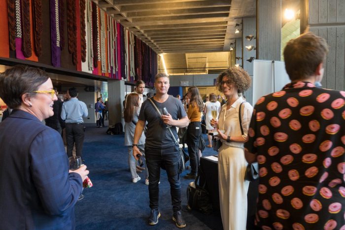 Guests mingling and socialising in foyer of John Clancy Auditorium UNSW Sydney