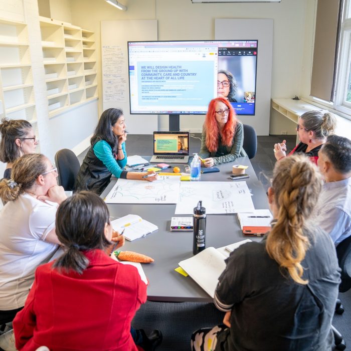 People doing group work sitting around desk