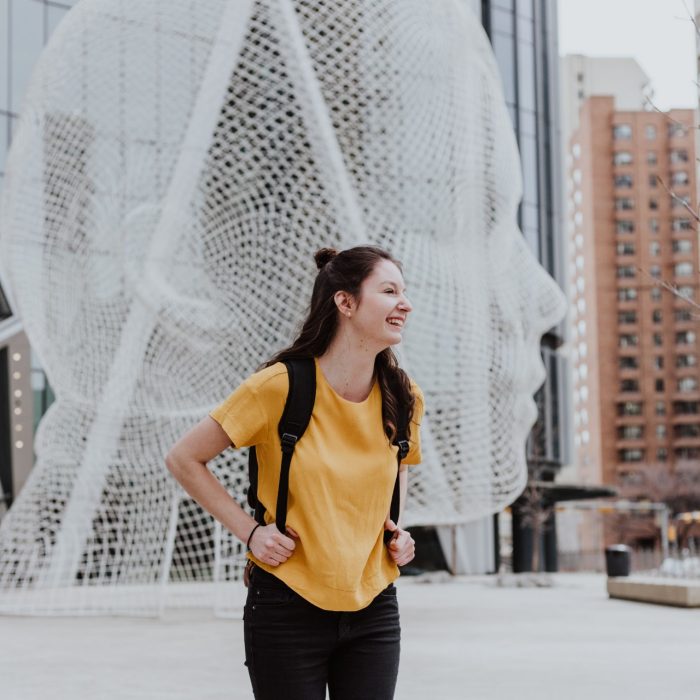 Student in a yellow shirt with a backpack