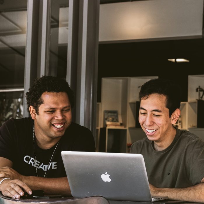 Two people looking at laptop screen