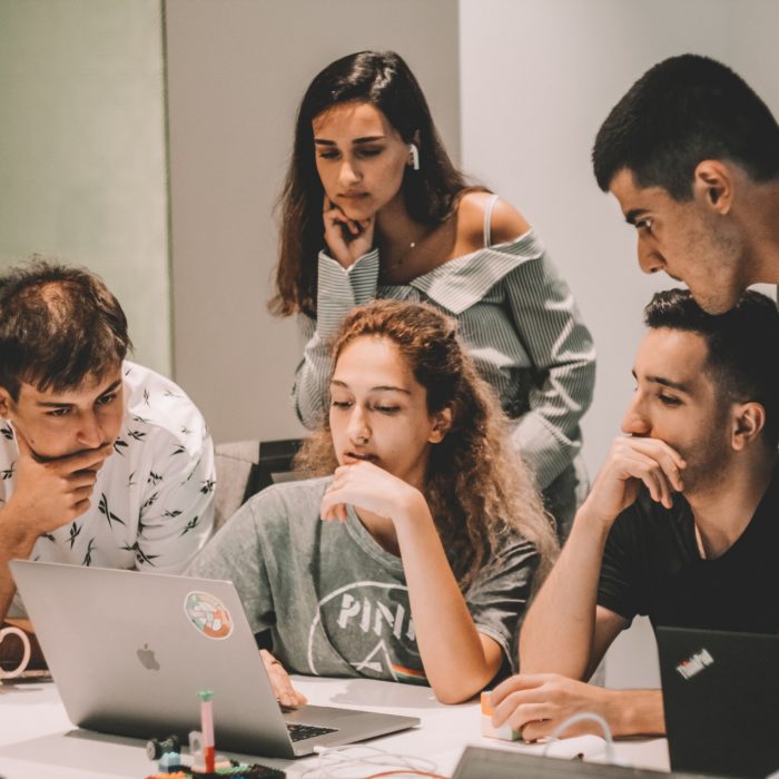 Group of students looking at laptop screen