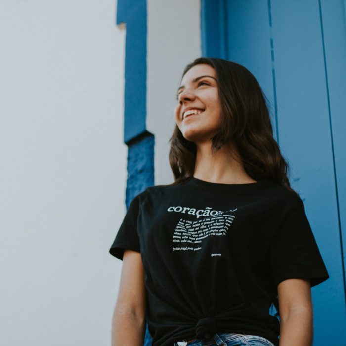 Woman in black t-shirt standing in front of a white and blue wall