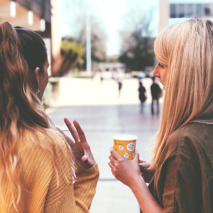 Two women having a chat at the main walkway