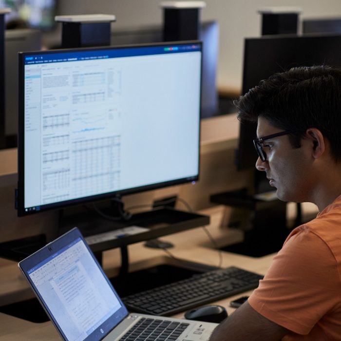 Students studying on computers in the business school computer lab.