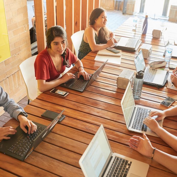 Students relaxing with computers, talking and studying at Kensington UNSW