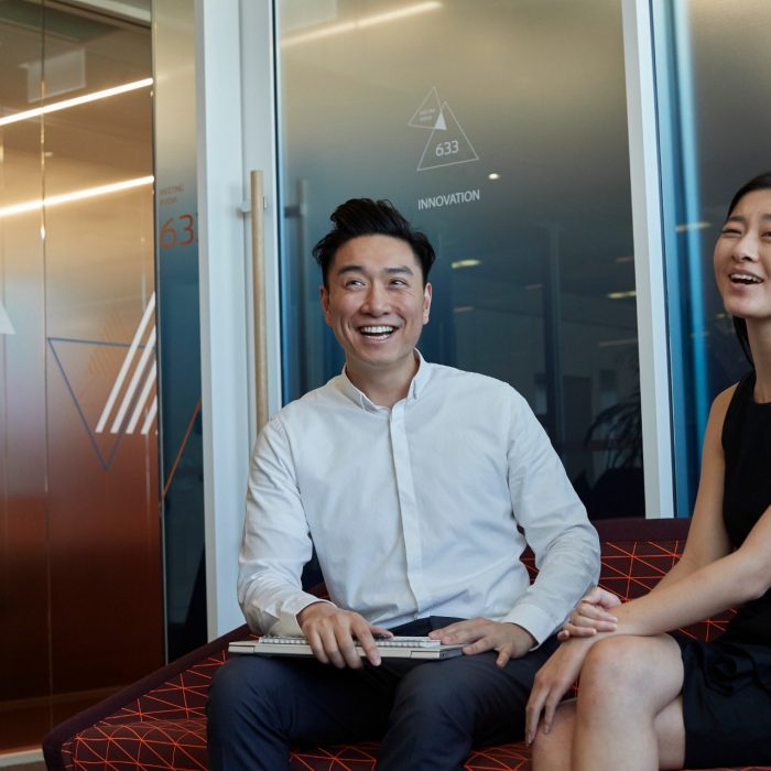 Post graduate students working on computers, talking and studying at the business school, Kensington UNSW