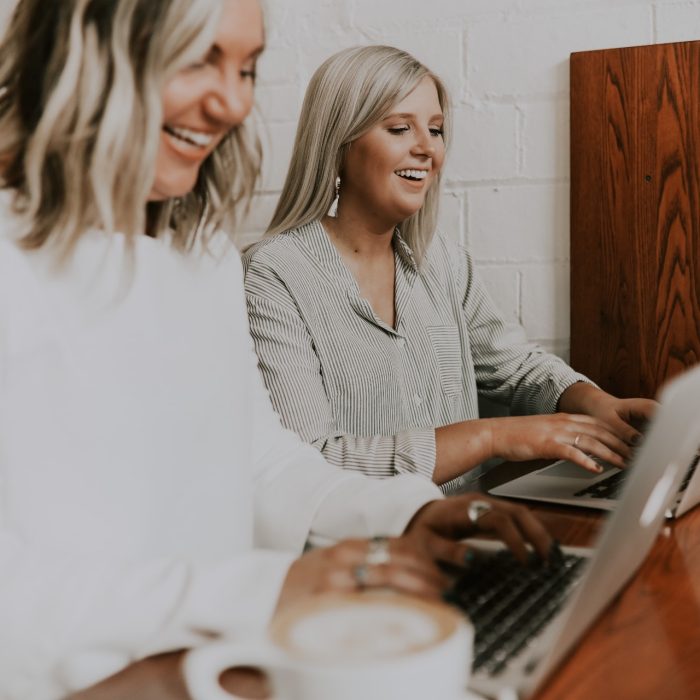 Two women using laptops