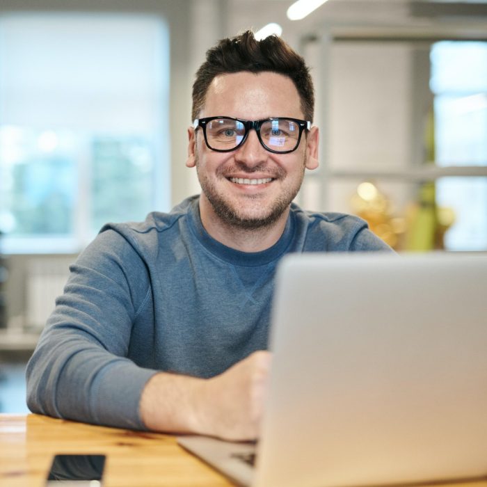 Man smiling over laptop