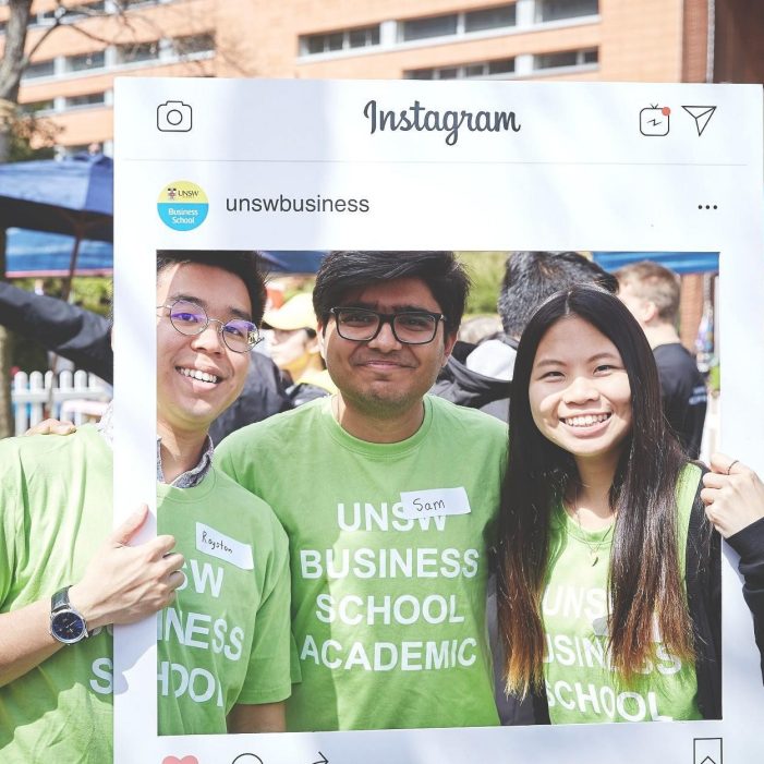 Three people standing in a photo frame