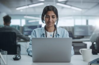 Diverse Office: Portrait of l Indian IT Programmer Working on Desktop Computer, Smiling. Female Software Engineer Creating Innovative App, Program, Video Game