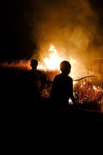 Indigenous Australians with a fire in a remote community.