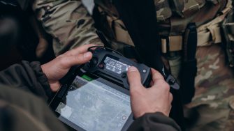 A group of Ukrainian military using tablet to operate the drone