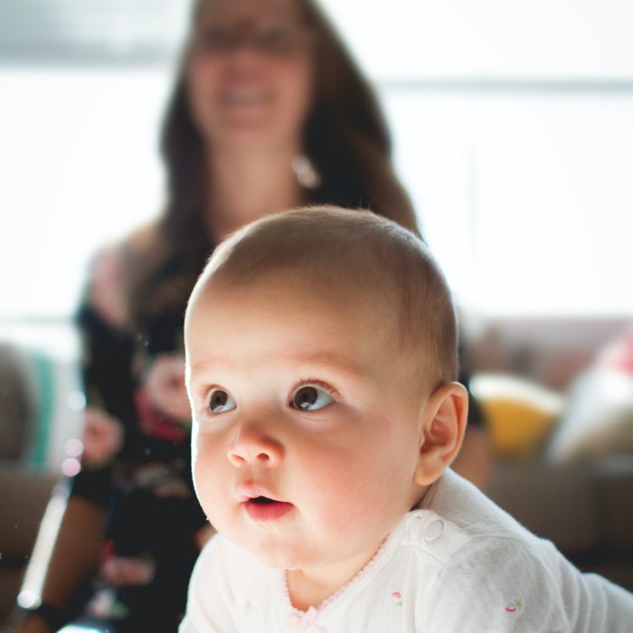 Baby crawling in front of mother