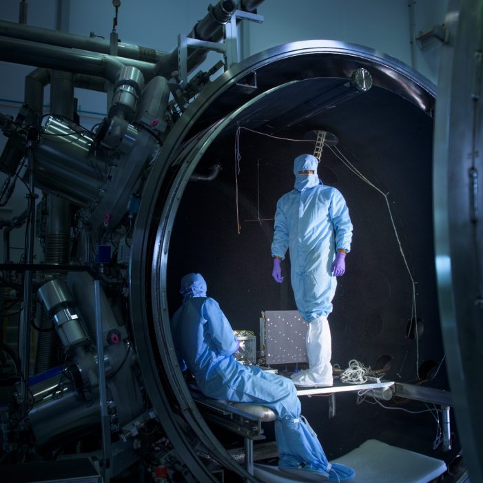 Engineers from the UNSW Canberra Space team work at the National Space Test Facility at Mt Stromlo during testing for the M2 mission.