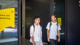 Two students chatting while exiting the Science & Engineering building on UNSW Kensington Campus