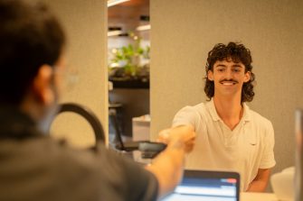 A student getting their ID card issued in The Nucleus: Student Hub