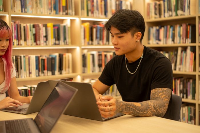 Students with their laptops in the Paddington Library