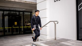 A student walking outside Block C on Paddington Campus