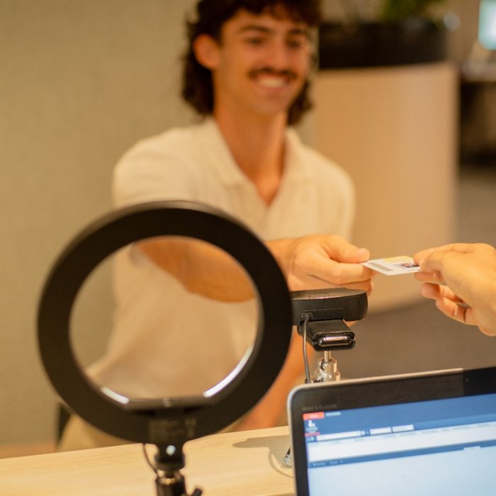 A student getting their ID card issued in The Nucleus: Student Hub