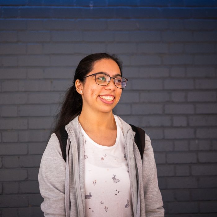 A student smiling outdoors on Kensington Campus