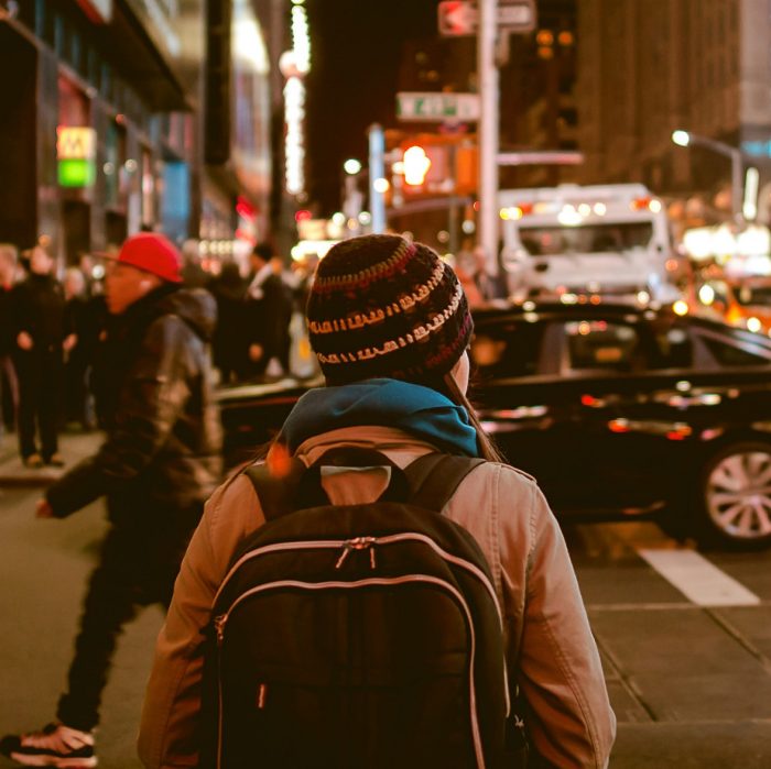 Person crossing highway during nighttime