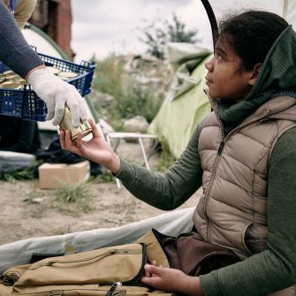 Child being handed a can of food