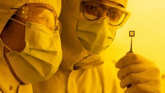 MMFI researchers inspecting the transparent transistor array in the clean room at the Australian National Fabrication Facility (UNSW)