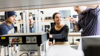 Engineering students in classroom with equipment