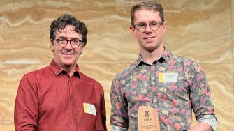 Will Gilbert receiving the Malcolm Chaikin Prize for Research Excellence in Engineering from Professor Ian Gibson, Deputy Dean