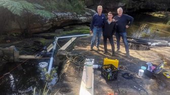 Yoel Jeremy, Iain Suthers, and Clive Holden with the operating model of the siphon fishway at Manly Creek