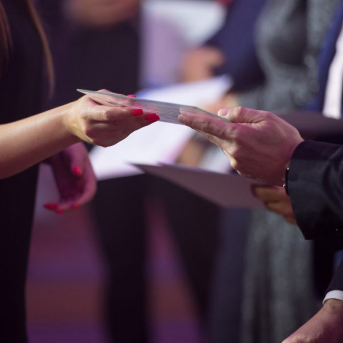 Close-up of people presenting awards