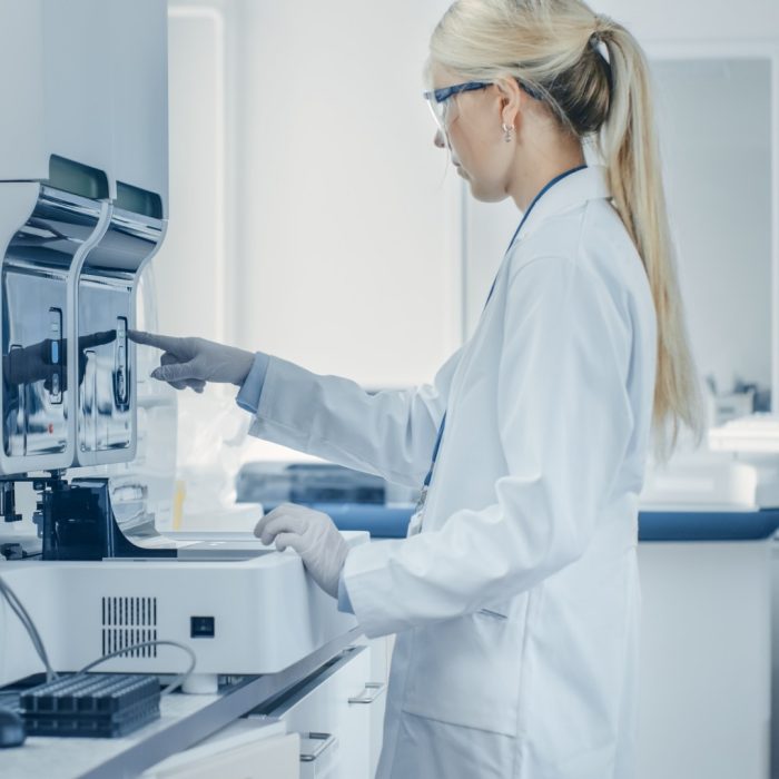 Female Research Scientist Analyzes Test Tube in Medical Machine, Works with Blood, Genetic Material Samples