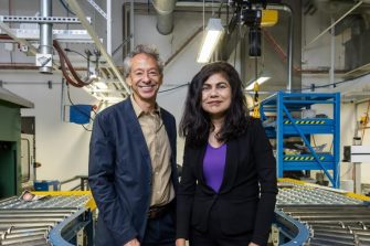 Two people standing in a factory