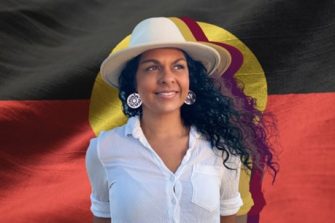 Portrait of Teela Reid before the Aboriginal flag