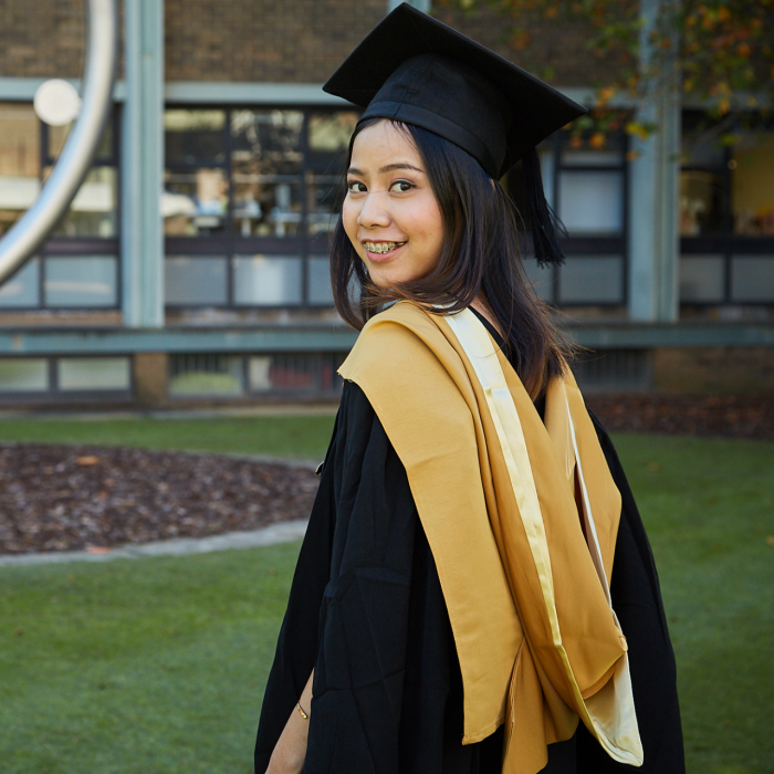 Graduating student in the library lawn