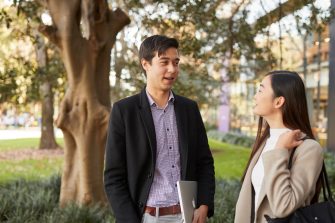 Law student talking with a classmate outside the Law building