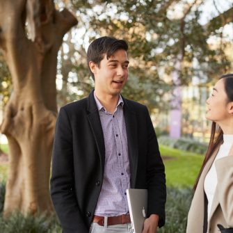 Law student talking with a classmate outside the Law building