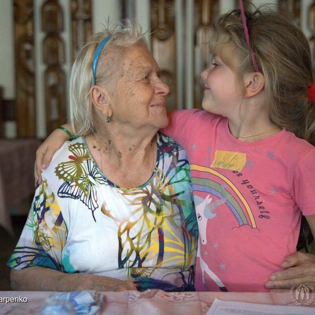 “I just worry for my grandchildren to be safe and have decent lives,” says Zhanna, 84. Zhanna saw many difficulties throughout her life. When she was only five, she lost her mother in one of the air raids during World War II.Later, she lost two of her children and raised one of her grandchildren, who was 15 when her mother passed away. Today, we meet Zhanna* (84 years old) when she is taking care of her great-grand daughter Milana for two weeks, while her granddaughter Nadiia (33) is away looking for a place to live in Kyiv where she recently found employment and where she will be taking both Zhanna and Milana to live.For four months, Zhanna is staying in one of the collective centres in Zakarpattya oblast in the west of Ukraine. She was evacuated from Lyman village near Odesa amid heavy fighting and shelling. The village is now occupied and Zhanna has no connection with her other family members. “When the war came to Lyman, it was absolutely terrible. I was lying in the corridor, and there were loud sounds of explosions everywhere,” says Zhanna. Her granddaughter, who left Lyman right after the war started, insisted that Zhanna flee the danger.After the house windows were broken, she asked volunteers to help evacuate her grandmother.“Volunteers knocked on my door and said that I have 15 minutes to pack my belongings and leave. There were 20 people in the bus evacuated on the same day. We had to lie low as the bus was passing the dangerous areas where the fighting was ongoing, and the bullets were flying,” recalls Zhanna.After four months in the collective centre, Zhanna has warm words about the people she met.“I have received so much support from local people and from other IDPs. I feel that all the kindness expressed towards me somehow lifts my spirits and gives me health, and I become stronger,” said Zhanna. ; 