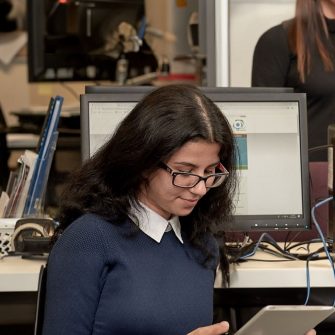 Image of two KLC Students learning in an office